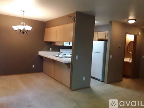A kitchen with brown cabinets and a white countertop.