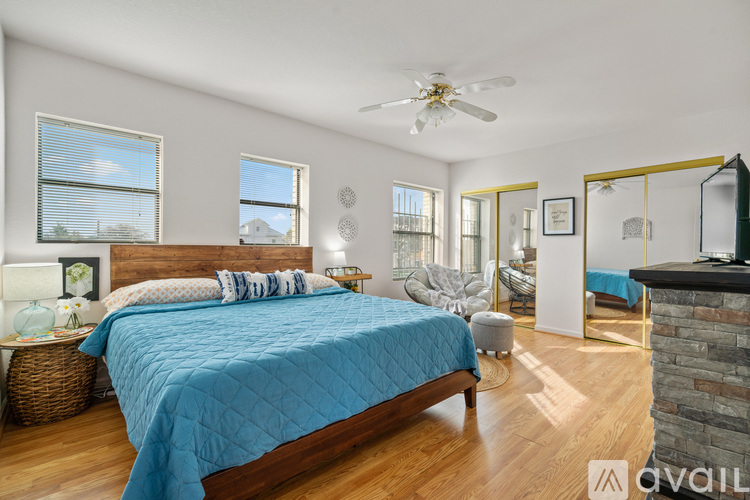 A bedroom with a large bed and a ceiling fan.
