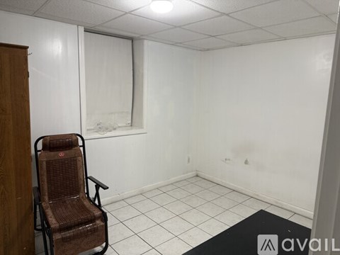 A room with a chair and a sign that says "available".