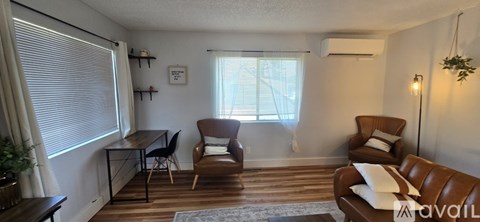 A living room with a brown couch and a brown chair.