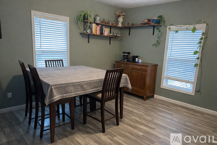 A dining room with a table set for four.