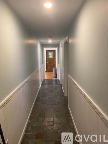 A hallway with a door at the end.