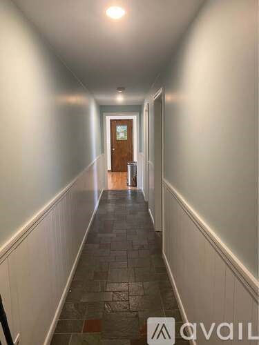 A hallway with a door at the end.