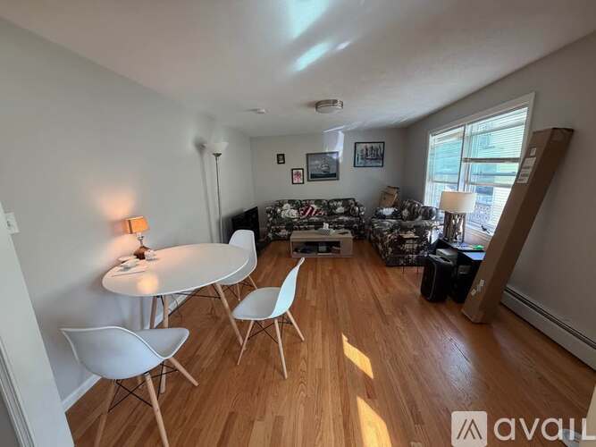 A living room with a white table and chairs.