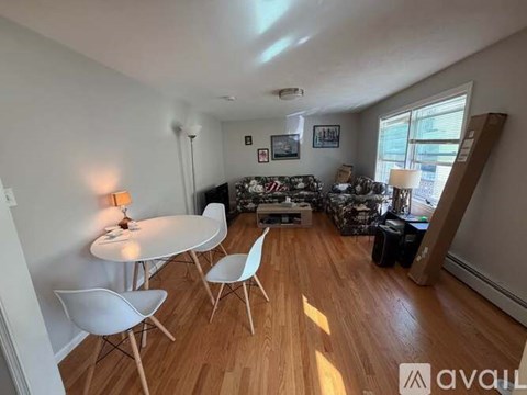 A living room with a white table and chairs.