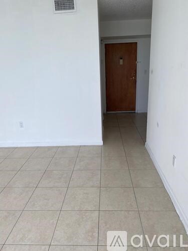 A room with a tiled floor and a wooden door.