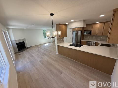 A modern kitchen with wooden cabinets and a central island.