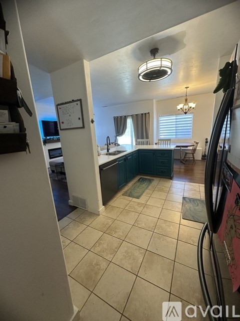 A kitchen with a white ceiling and a white door.