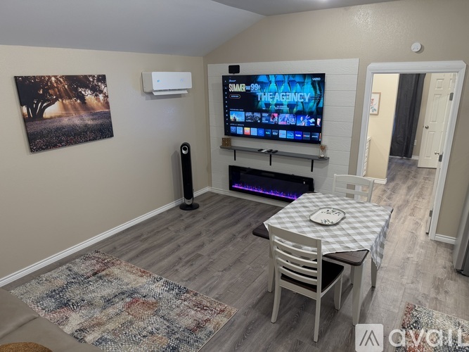 A living room with a television playing a show called The Agency.
