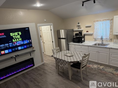 A living room with a flat screen TV and a fireplace.