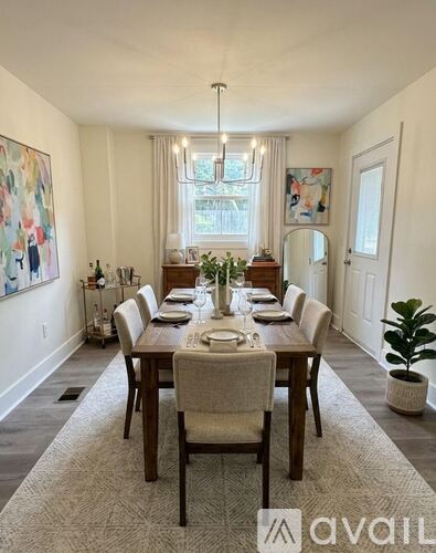 A dining room with a long table set for a meal.
