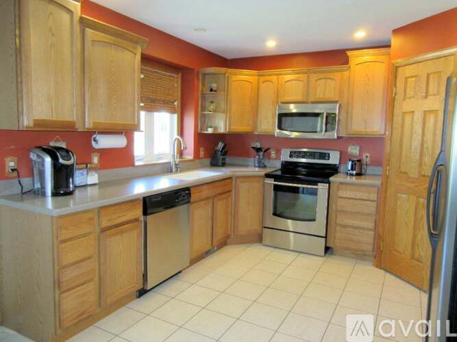 A kitchen with wooden cabinets and a white countertop.