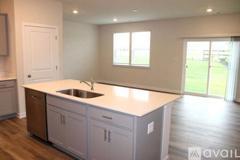A kitchen with white cabinets and a sink.