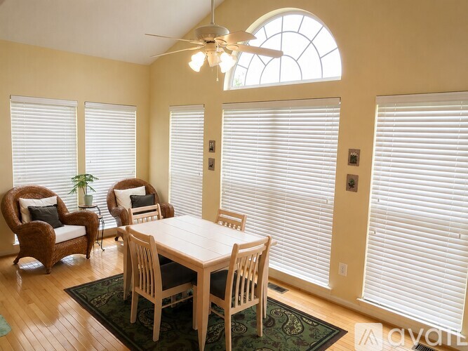 A dining room with a table and chairs.