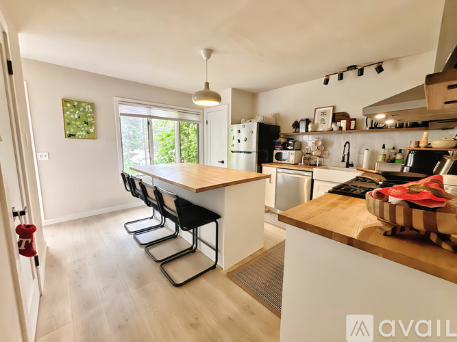 A kitchen with a white fridge and a white oven.