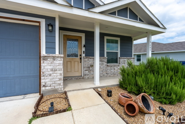 A house with a blue garage door and a brown door.