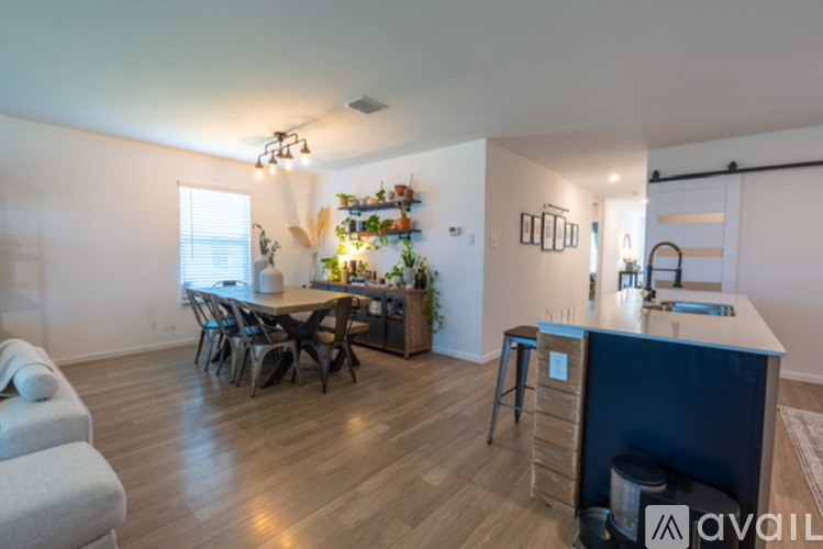A kitchen area with a dining table and chairs.