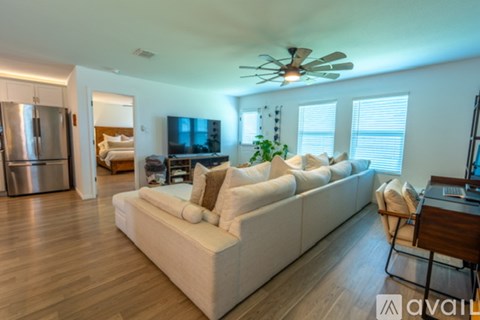 A living room with a white couch and a television.