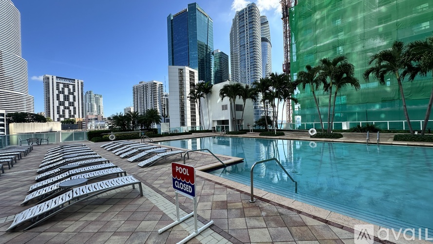 A pool area with a pool closed sign in front of a building.