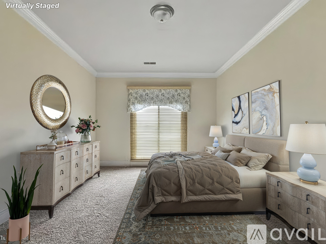 A bedroom with a large bed, a dresser, and a mirror.