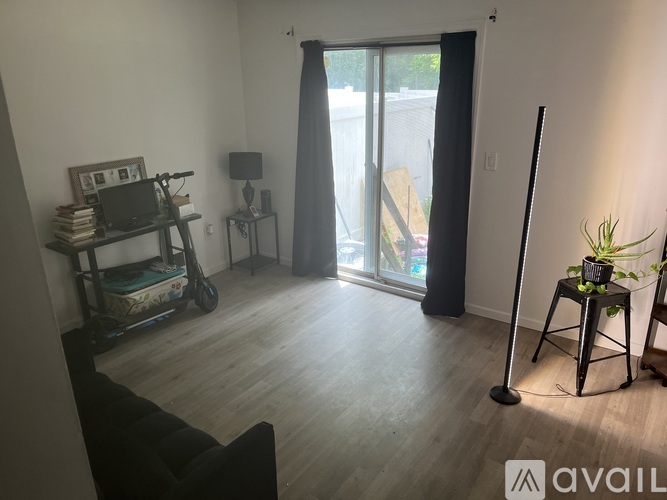 A living room with a sliding glass door leading to a balcony.