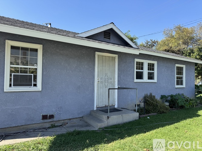 A small house with a white door and windows.