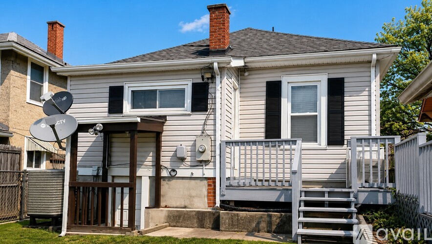 A house with a satellite dish on the roof.