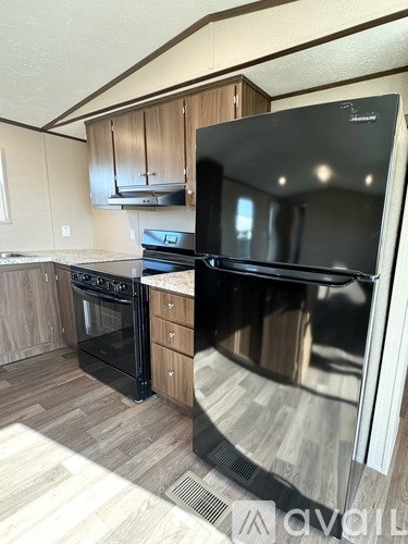 A modern kitchen with a black oven and stove.