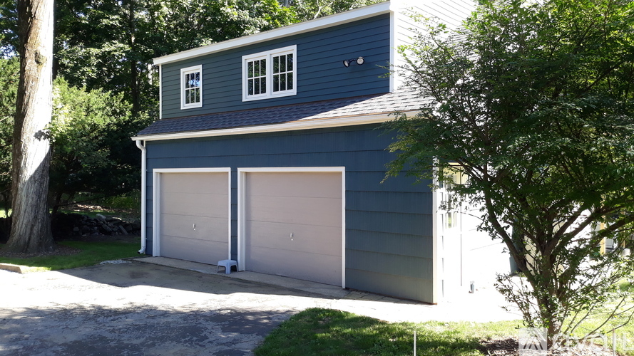 A two-car garage is attached to a house.
