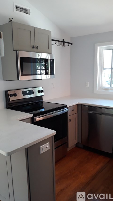A kitchen with a stove top oven and microwave above it.