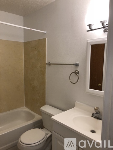 A bathroom with a toilet, sink, and bathtub.
