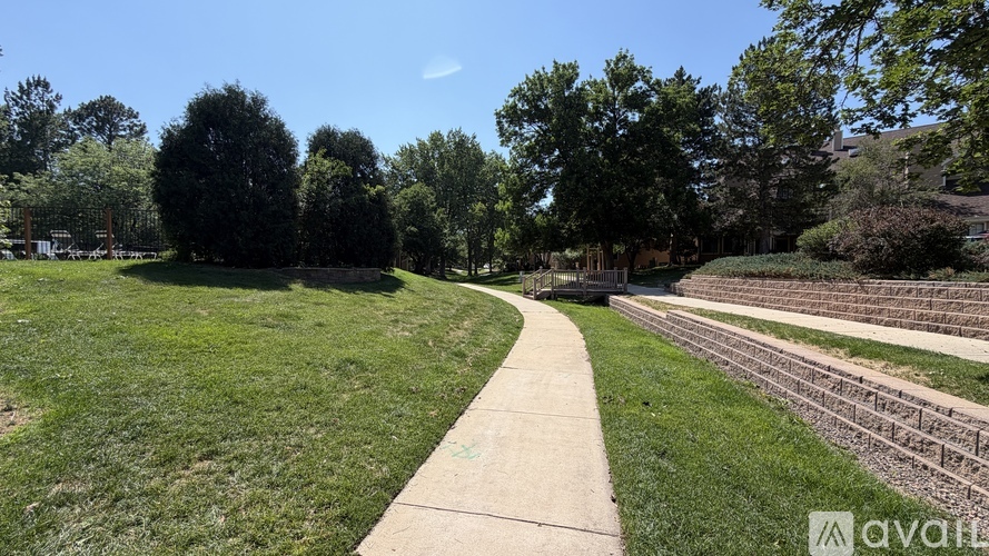 A park with a walking path and trees.
