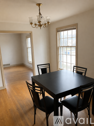 A dining room with a table and chairs.
