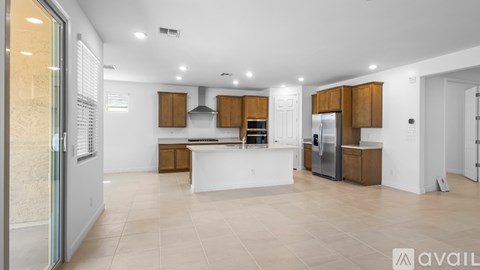 A modern kitchen with wooden cabinets and a white island.