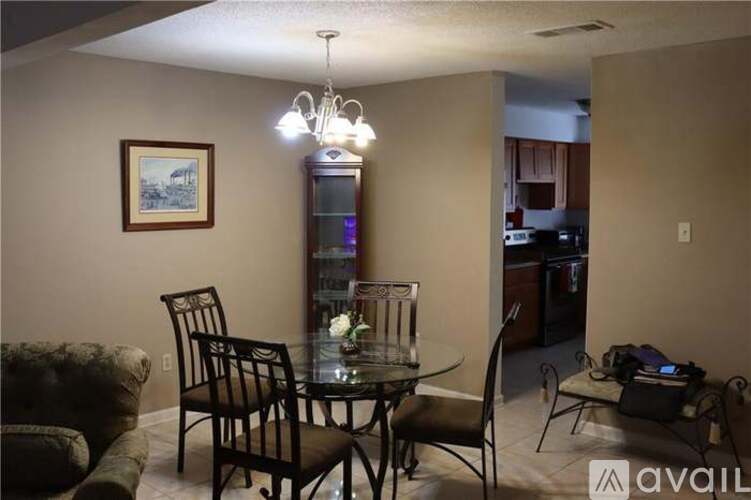 A dining room with a glass table and chairs.
