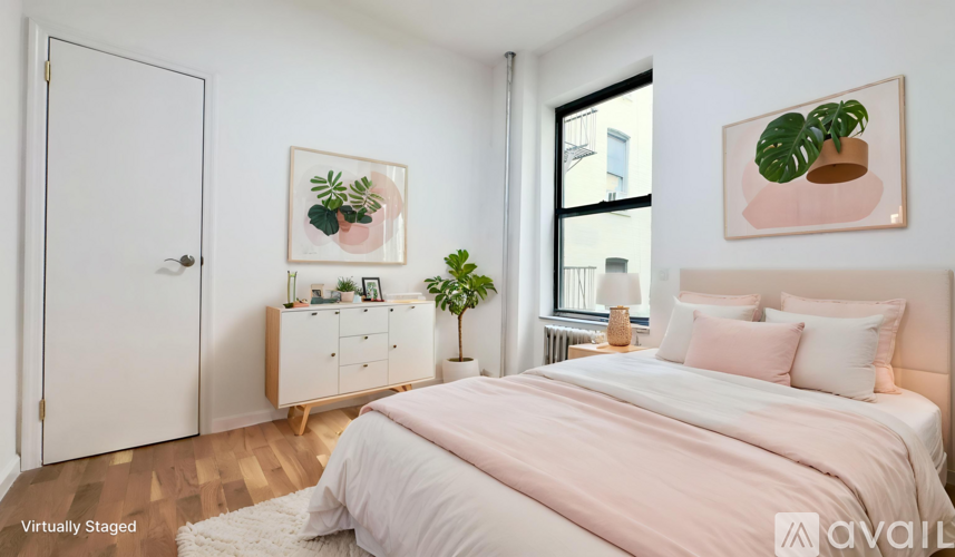 A bedroom with a large bed and a white door.