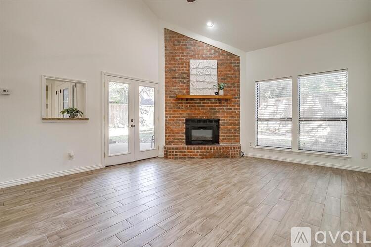 A room with a fireplace and a brick wall.