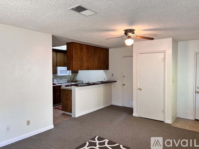 A kitchen area with a counter and cabinets.