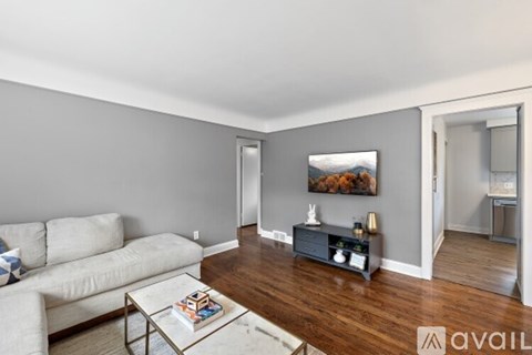 A living room with a white couch and a coffee table.