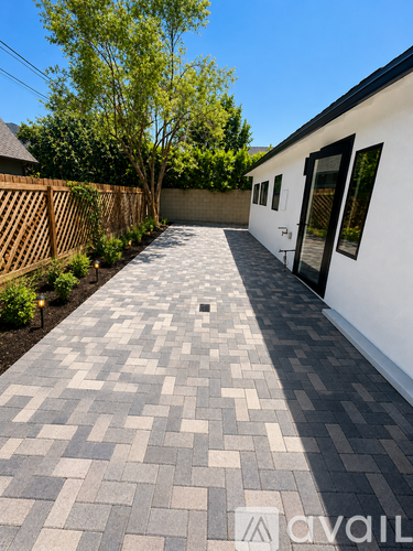 A white house with a grey tiled walkway leading to the front door.
