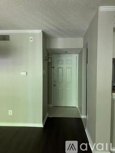 A hallway with a door at the end.