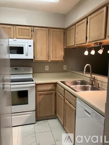 A kitchen with wooden cabinets and stainless steel appliances.