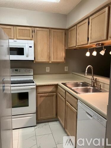 A kitchen with wooden cabinets and stainless steel appliances.