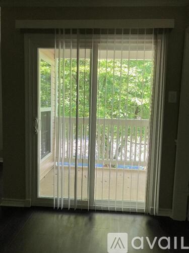 A patio with a pool and a white fence is visible through a sliding glass door.