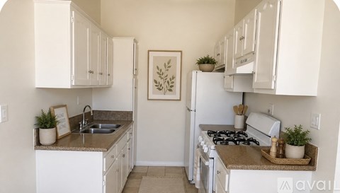 A kitchen with white cabinets and appliances.
