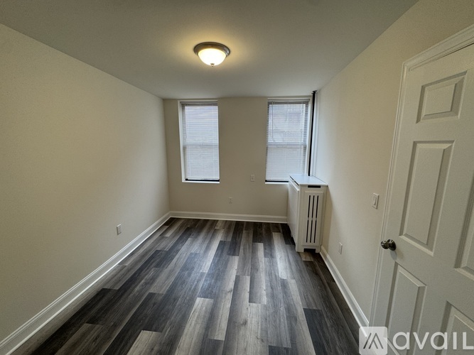 A room with wood flooring and a window.