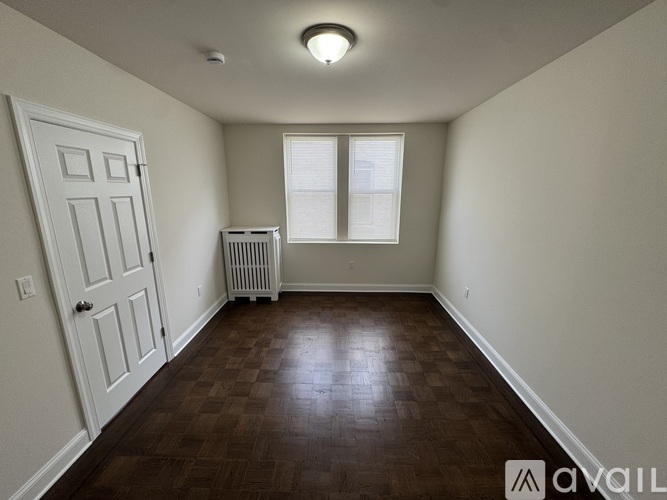 A room with a white door and a window with a white frame.
