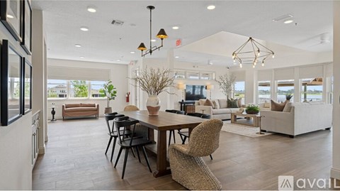A modern dining room with a large table and chairs.