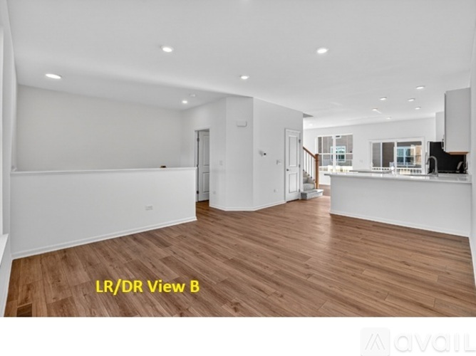 A spacious room with wooden flooring and white walls, labeled as "LR/DR View B".