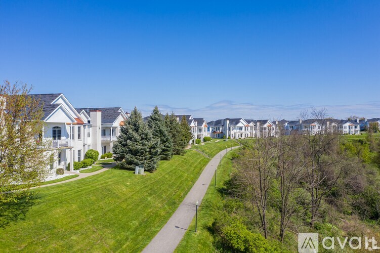 A row of houses with a grassy area in front.